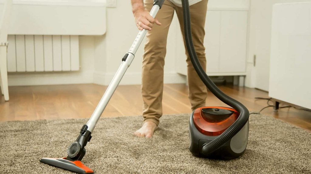 vacuuming carpet with a modern carpet vacuuming equipment